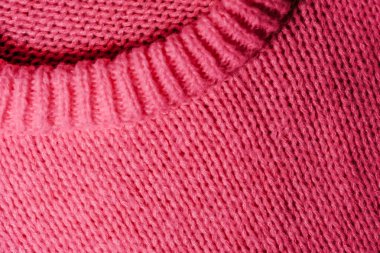 A detailed view of a pink sweater with a noticeable hole in the center, showcasing the texture and color of the fabric. clipart
