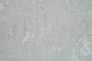 Beyaz boyayla kaplı beton bir duvarın detaylı görüntüsü. Kaba yüzeyin dokusu yakından görülebilir..