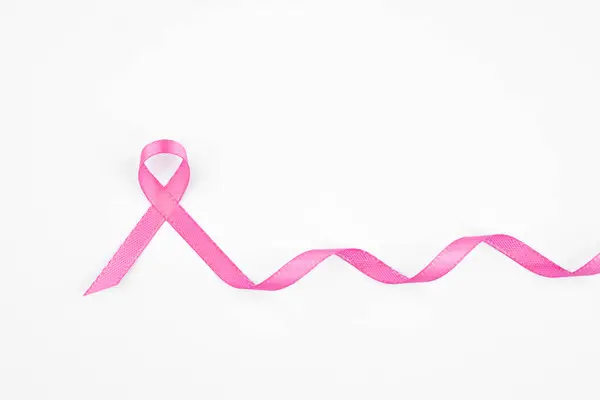 Stock image A pink ribbon is elegantly arranged to signify breast cancer awareness and support.