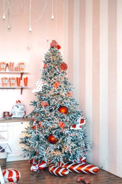 A beautifully decorated Christmas tree stands in a warm, cozy room, adorned with red and white ornaments, surrounded by festive decor and a welcoming atmosphere. clipart