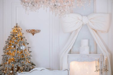 A warm winter environment showcases a stunning Christmas tree adorned with lights and ornaments. Nearby, a white bow decoration adds elegance. Soft lighting creates a festive ambiance. clipart