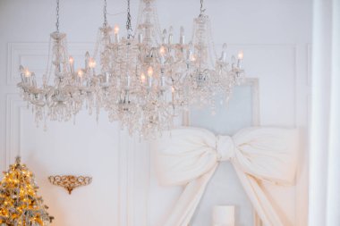 Göz kamaştırıcı bir kış ayarı. Parlak bir avize ve güzel dekore edilmiş bir Noel ağacı. Yumuşak ışıklandırma kutlamalar için mükemmel rahat ve şenlikli bir atmosfer yaratır..