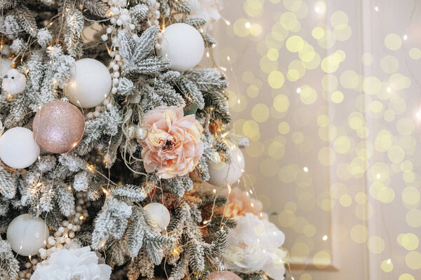 A stunning Christmas tree is adorned with delicate ornaments and soft lights, creating a warm winter atmosphere.