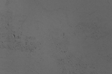 Düz, gri beton bir yüzey, hafif desenli, hafifçe aydınlatılmış..