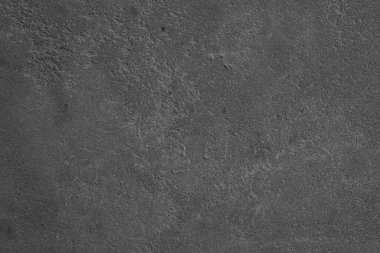 Kaba ve dokulu bir bitiş içeren gri bir yüzeyin yakın görüntüsü.