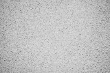 Kaba gri duvar dokusunun yakın görüntüsü düz olmayan yüzeyleri ve derinliği gösteriyor.