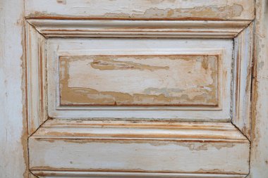 Eski bir ahşap kapı, bir hikaye anlatan boyaları ve detaylı panelleri gösteriyor..