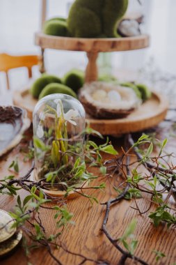 Güzel düzenlenmiş bir masa yeşil ve doğal dekorlu cam bir kubbeye sahiptir..