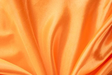 Pürüzsüz ve Parlak Bitirimli Lüks Turuncu Saten Kumaş. İpeksi arkaplan. 