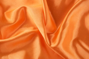 Pürüzsüz ve Parlak Bitirimli Lüks Turuncu Saten Kumaş. İpeksi arkaplan. 