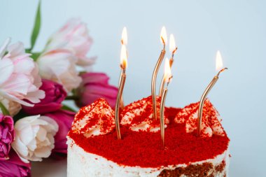 Kırmızı kadife pastaya yakın plan altın mumlar