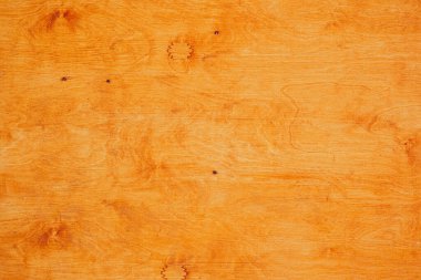 Doğal ahşap yüzeye yakın çekim. Açık turuncu renk ve ince tahıl desenleri var..