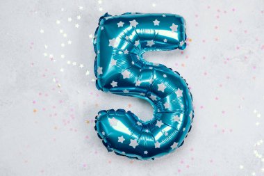 Beş numara şeklinde parlak mavi bir balon açık bir arka planda duruyor..