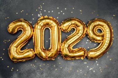 2029 'u oluşturan altın balonlar karanlık bir yüzeye dağıldı..