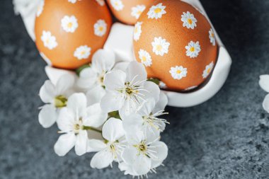 Taze beyaz çiçeklerin yanında çiçek desenli renkli yumurtalar..