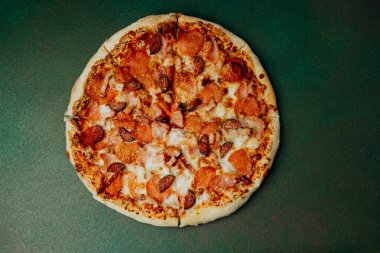 Erimiş peynir ve etle kaplı taze pişmiş pepperoni pizza..