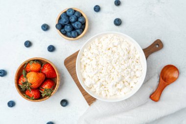 Kahvaltıda taze çilek ve yaban mersiniyle servis edilen kremalı süzme peynir..