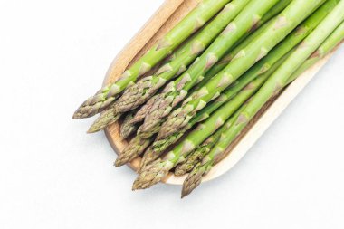 Yeşil kuşkonmaz mızrakları ahşap tepside pişirilmeye hazırdır..