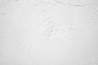 Karmaşık desenleri ve çizgileri olan beyaz desenli bir duvarın yakın plan görüntüsü.