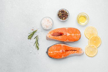 Somon filetoları limon dilimleri, otlar ve baharatlarla tezgahta hazırlanır..