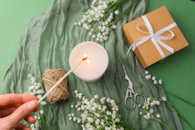 Çiçekli el feneri ve yeşil arka planda hediye.