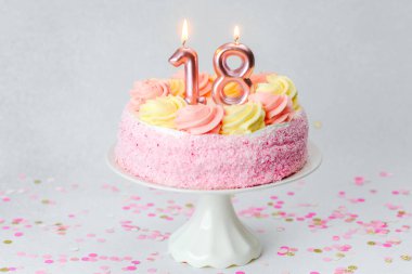 Pembe ve sarı kremalı renkli pasta 18 yaşına basan kutlamaları kutluyor..