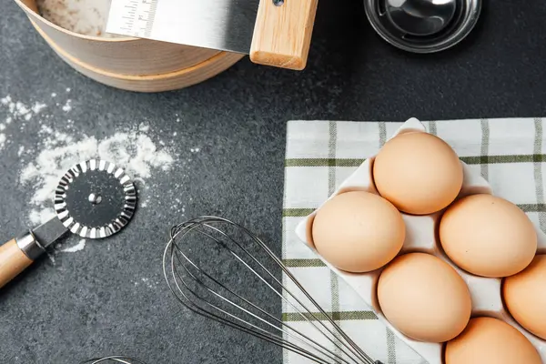 Yumurta, un ve aletler mutfak tezgahında pişirmeye hazır..