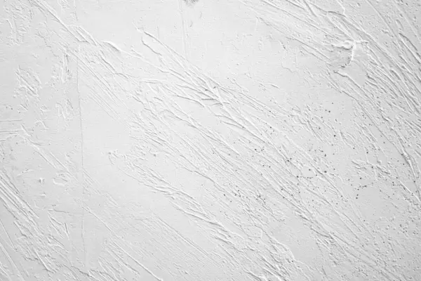 Beyaz bir duvara yakın çekim yap, desenli desenler ve ince çizikler göster..