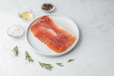 Biberiye ve tuzlu beyaz tabakta jambon dilimleri.