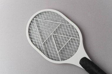 Electric mosquito swatter on gray backgroun