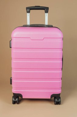 Pembe, sert kabuklu bavul. Yakın görüş, konsept seyahat, moda bagaj hizmetleri.