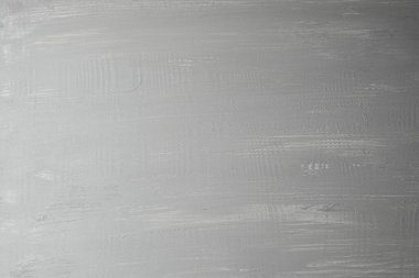 Yüzeyde düzgün gri bir doku var. Nazik, kıvrımlı desenler ve çizgiler var..