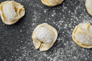 Mutfak tezgahında dağınık un tozlu cappelletti makarna.