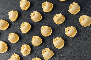 Koyu arka planda çapraz dağınık çiğ kapel makarna yakın plan