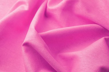 Yumuşak kırışıklıkları olan pembe pamuk kumaş eko tekstil kavramını kapat