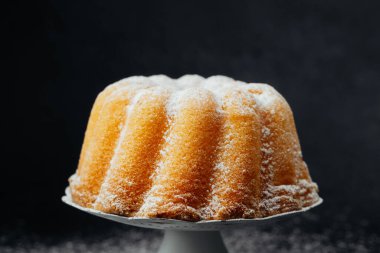 Koyu taşlı, beyaz tezgahta altın demet kek.