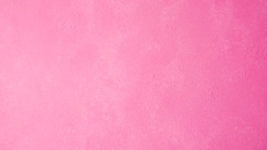 Parlak, pembe, soyut bir arkaplan yüzeyinde ince kaba bir dokuya sahiptir, modern ve canlı bir dekoratif zemin oluşturur..