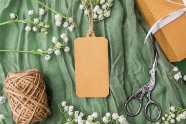 Çiçekli kraft etiketi ve hediye paketi aksesuarlarının üst görünümü