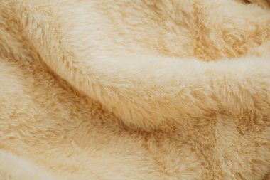 Evcil hayvan ürünü reklamları veya kış modası için kremsi bej kürk dokusu