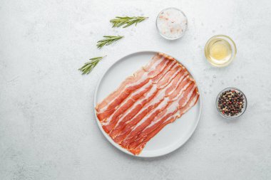 Pişmemiş pastırma şeritleri beyaz tabakta biberiye ve baharatla.