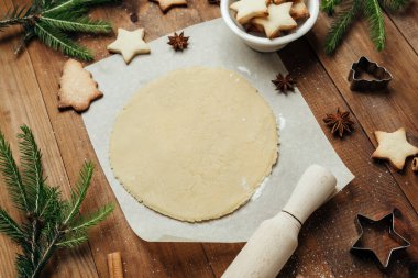 Noel aşçılığı ve kırsal gıda konsepti için ahşap masa üzerinde şenlikli kurabiye hamuru ve pişirme seti