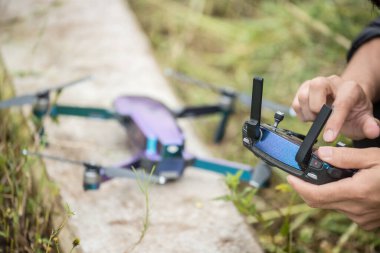 Cropped shot view of human hands using the remote control for control a camera drone.