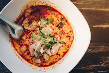 Tom Yum Goong (or Spicy prawn soup) mixed with meat ball noodles, Thai style and iconic popular taste of Thai foods.