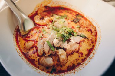 Tom Yum Goong (or Spicy prawn soup) mixed with meat ball noodles, Thai style and iconic popular taste of Thai foods.