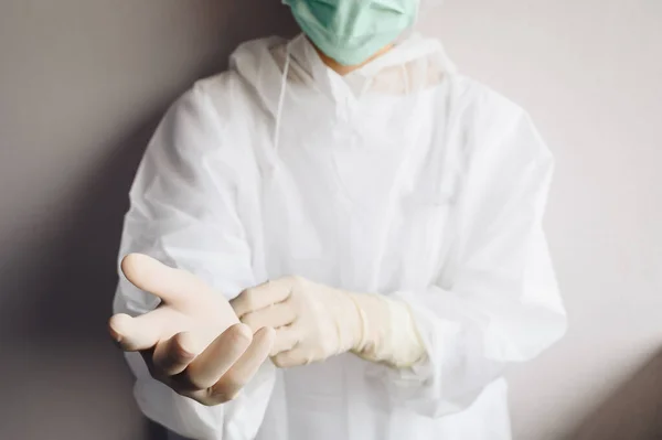 Cropped shot of healthcare worker wearing PPE suit for working in hospital during Covid-19 pandemic. PPE is equipment that will protect the user against health or safety risks at work.