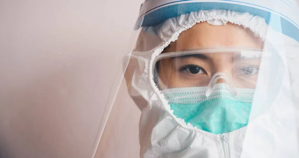 Cropped shot of confidence healthcare worker while wearing PPE suit before working in hospital during Covid-19 pandemic. PPE is equipment that will protect the user against health or safety at work.
