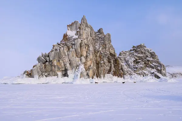 View of Shaman rock one of sacred place in frozen lake Baikal in winter season of Siberia, Russia. This rock is a subject of many popular legends and myths about Baikal Lake and Angara river.