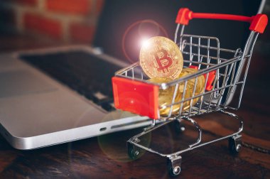 Dizüstü bilgisayardaki tramvay oyuncağındaki Bitcoin jetonu. Bitcoin popüler bir kripto para birimi, sanal para birimi veya dijital para birimidir..