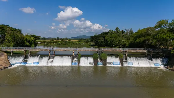 stock image Aerial view of small spillway in Pa Daet district in Chiang Rai province of Thailand. Spillway, passage for surplus water over or around a dam when the reservoir itself is full.