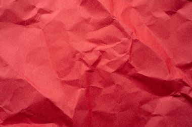 Buruşmuş kırmızı kağıt yaprak dokusu ve arka planının tam kare görüntüsü.